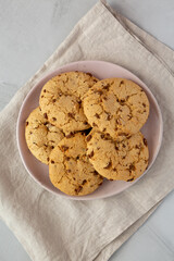 Homemade Cookies with Milk Chocolate Chunks on a Plate, top view. Flat lay, overhead, from above.