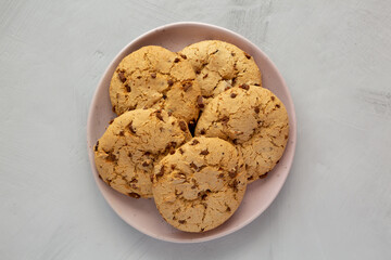 Homemade Cookies with Milk Chocolate Chunks on a Plate, top view. Flat lay, overhead, from above.