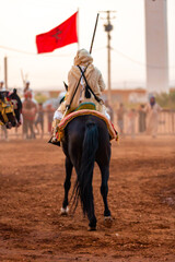 Equestrians participating in a traditional fancy dress event named Tbourida in Arabic dressed in a traditional Moroccan outfit and accessories of the knights