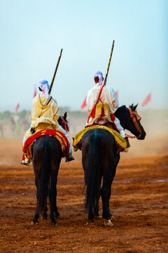 Equestrians participating in a traditional fancy dress event named Tbourida in Arabic dressed in a traditional Moroccan outfit and accessories of the knights
