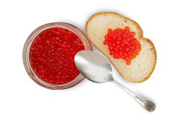 Artificial red caviar lies in a glass jar and on a piece of white bread; there is a metal spoon on...