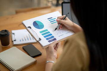 Cropped image of businesswoman analyzing business results by exploring trends of popular products in the market