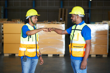 workers greeting fist bump before work in the warehouse storage