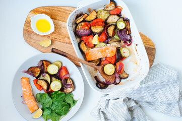 cooking healthy diet vegetarian food - mixed oven roasted vegetables with baked salmon filet....