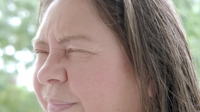 close-up of mature charismatic woman 50 years with closed eyes, eye pain treated medical emergency, ocular ache, sharp sensation, foreign body sensation, vision changes or severe discomfort