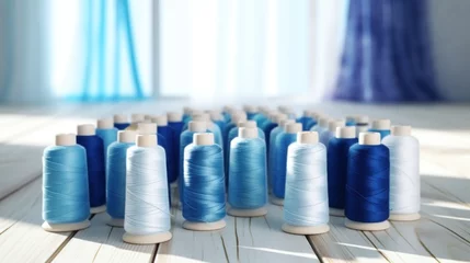 Foto op Canvas Different shades of blue colored sewing thread spools on white table. © Pro Hi-Res