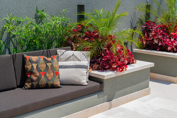 Elegant decorated balcony with modern outdoor furniture and plants
