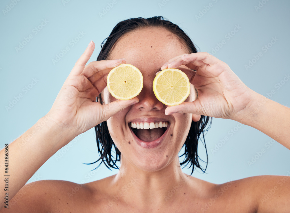 Sticker Eyes, smile or happy woman with lemon for skincare or beauty in studio on blue background. Crazy, dermatology shine or funny person with natural fruits, vitamin c or face glow for wellness or health