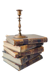 An old vintage metal bronze candlestick on the pile of old books. isolated on a white background