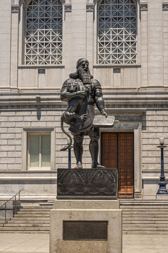 San Francisco, CA, USA - July 12, 2023: Statue of historic Ashurbanipal Assyrian king or Enkidu holding a wriggling lion and a tablet, at south facade of Asian Art Museum.