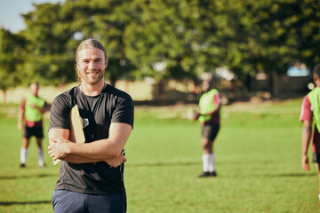 Portrait, fitness and a rugby coach on a field with his team training or getting ready for match...