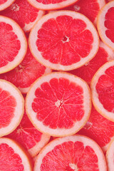 Grapefruit red juicy slices background. top view