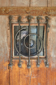 Artfully barred window on a castle gate.