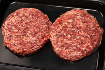 Raw minced beef isolated on a black background.