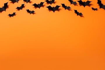 Halloween composition - black bats on orange background, copy space, top view, greeting card, design mock up