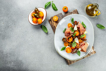 Salad with Prosciutto, ham jamon, tomatoes, cheese. Cold snacks. banner, menu, recipe place for text, top view