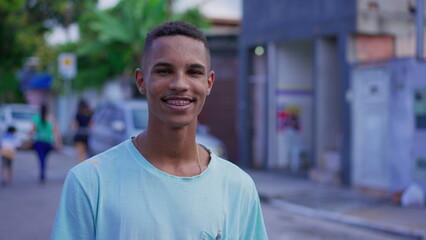 Authentic Young South American Man in 20s, Smiling at Camera in Urban Street Scene