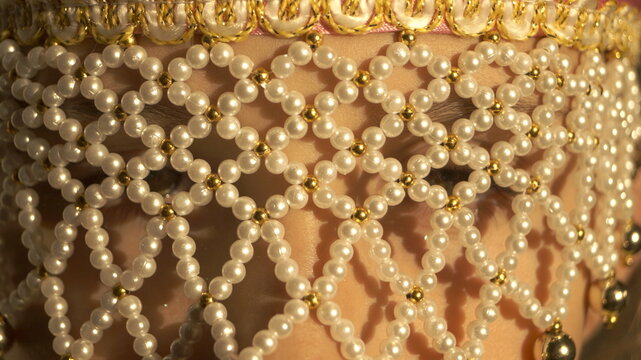 girl with a pearl mesh on her face