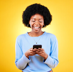 Woman, smile and typing on smartphone on in studio, reading social media and funny meme on yellow background. Happy african model, cellphone and download games, dating app or multimedia notification