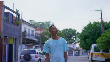 One pensive young black Brazilian man looking up at sky in contemplative and thoughtful expression....
