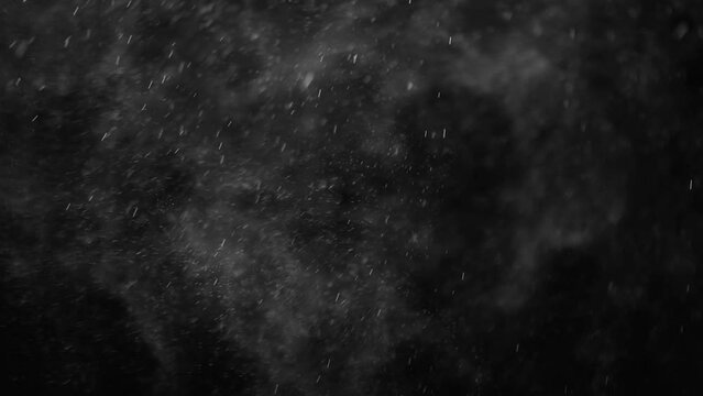 small drops of rain, snow on a black background. wind. Natural background. slow motion