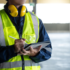 Building inspector man using digital tablet checking safety and security system. Asian male worker...