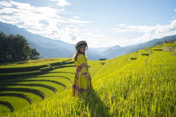 Foto auf Acrylglas Mu Cang Chai A farmer woman with fresh paddy rice terraces, green agricultural fields in countryside or rural area of Mu Cang Chai, mountain hills valley in Asia, Vietnam. Nature landscape. People lifestyle.