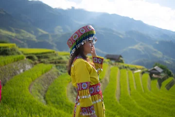 Photo sur Plexiglas Mu Cang Chai A farmer woman with fresh paddy rice terraces, green agricultural fields in countryside or rural area of Mu Cang Chai, mountain hills valley in Asia, Vietnam. Nature landscape. People lifestyle.