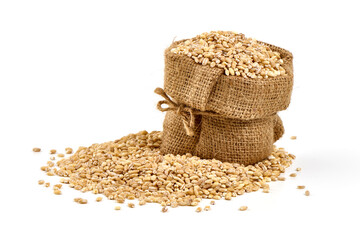 Pearl barley in rustic burlap, isolated on white background.