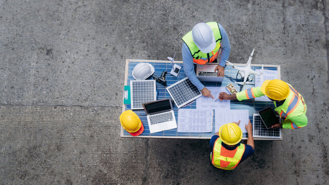 Team worker checking inventory about solar cell and turbine at Container cargo harbor for import, and export industries. Logistics concept.
