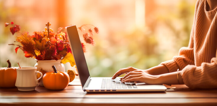 Woman typing on laptop in Autumn. Autumn pumpkins with using a laptop computer from above, digital ai	
