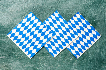 Oktoberfest pattern on napkins on green vintage table, top view