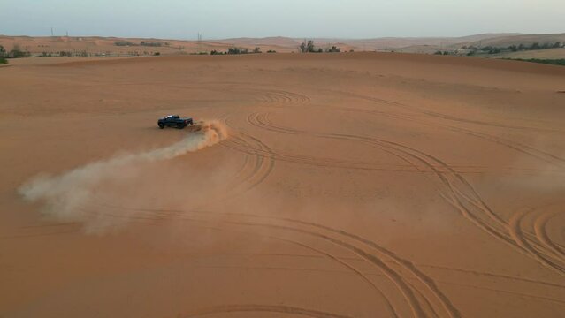 car racing in the dunes in the desert at sunset in saudi Arabia