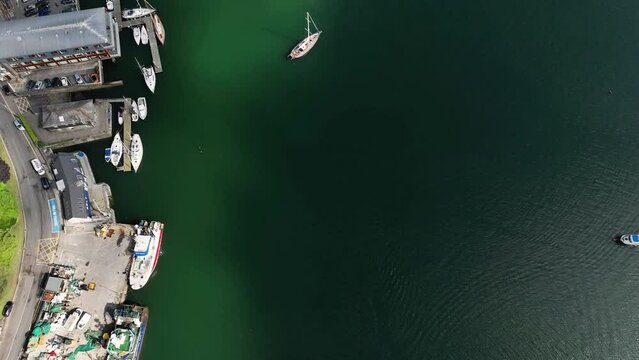 Aerial drone footage of Kinsale Pier with ships and sailboats 4k Ireland Summer
