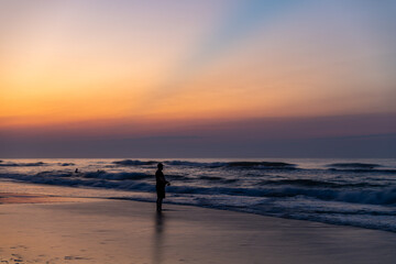 Fototapeta na wymiar Surfcaster on the Beach before the Sunrise
