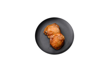 Delicious juicy chicken thighs baked with salt, spices and herbs in a ceramic plate