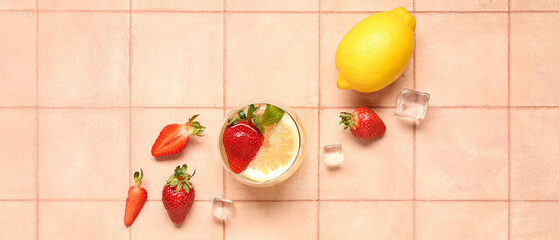 Glass of fresh strawberry lemonade and ingredients on color background, top view