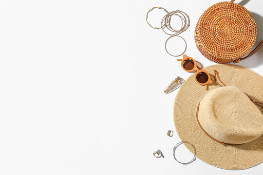 Jewelry with sunglasses, bag and summer hat on white background