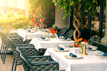 The tables of the street restaurant are prepared for customers