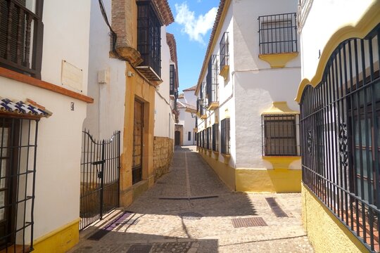 street with yellow and white houses in the old town of Ronda, Andalusia, Malaga, Spain