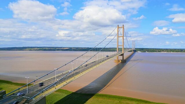 Aerial drone view of Humber Bridge, 12th largest suspension span, gracefully crossing River Humber, connecting Lincolnshire to Humberside with traffic.