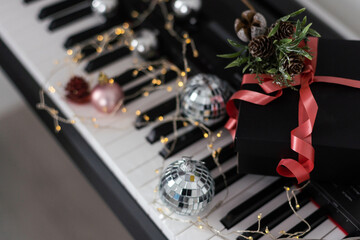 Christmas ball on piano keys. Carol music concept