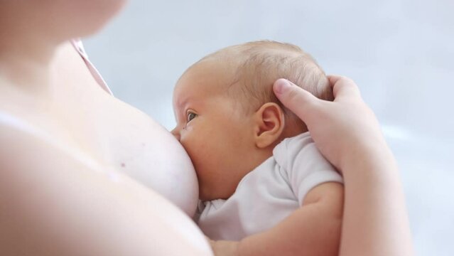Concept of breastfeeding a newborn baby at home, enjoying the moment of tenderness, feeling unconditional love, lactation and natural nutrition