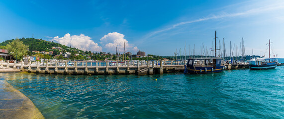 A panorama view past boats moored on a jetty at Portoroz, Slovenia in summertime