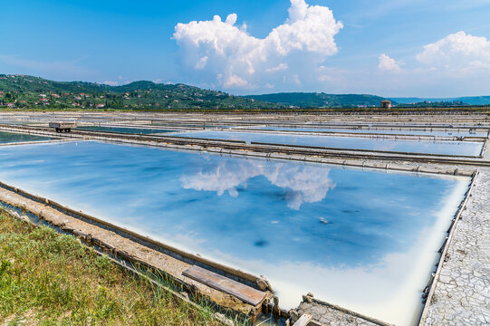 A view of reflections in the crystallisation pools at the salt pans at Secovlje, near to Piran, Slovenia in summertime