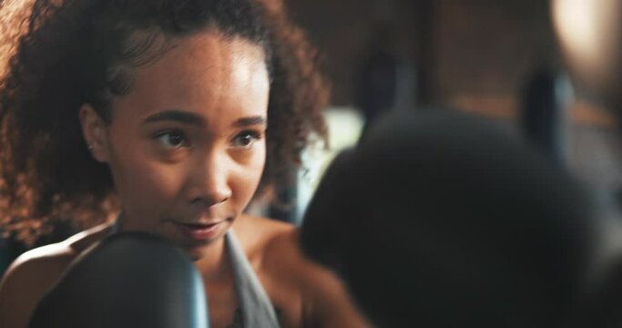 Sports, woman face and boxer punch training, fist impact challenge and practice power, cardio fitness or exercise. Action, fighter gloves and strong athlete boxing, self defense or determined workout