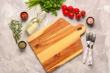 Composition with wooden cutting board, fresh spices and tomatoes on light background