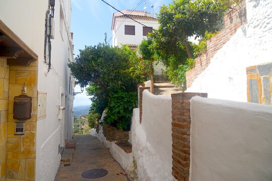 alley in an old Andalusian mountain village with white houses and a view of the landscape, tourism, Estepona, Andalusia, Malaga, Spain