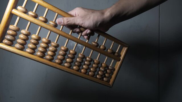 sempoa. Made of wood. Shaking the wooden beads of the abacus up and down. accounting, calculator, finance, mathematics, retro, traditional, computing.