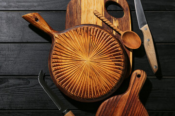 Different cutting boards on black wooden background